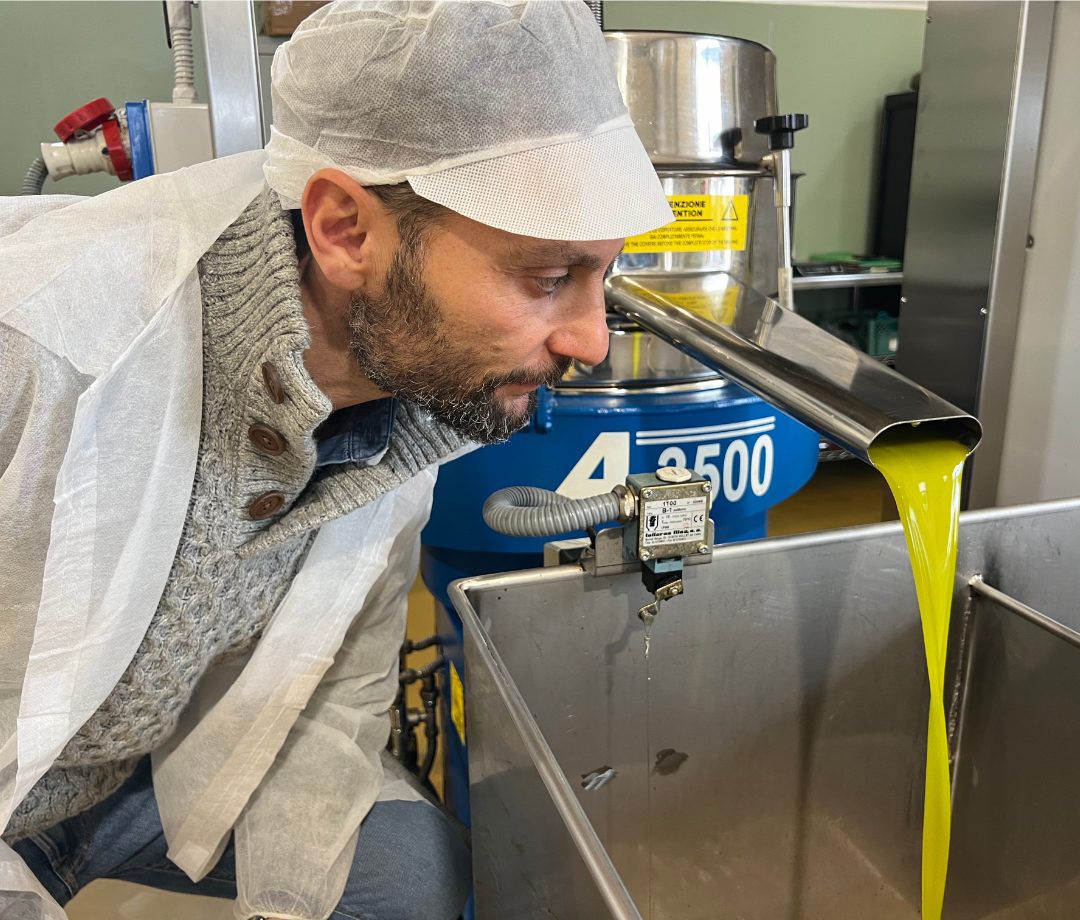 Giovanni osserva da vicino l’olio appena estratto mentre scende dal separatore
